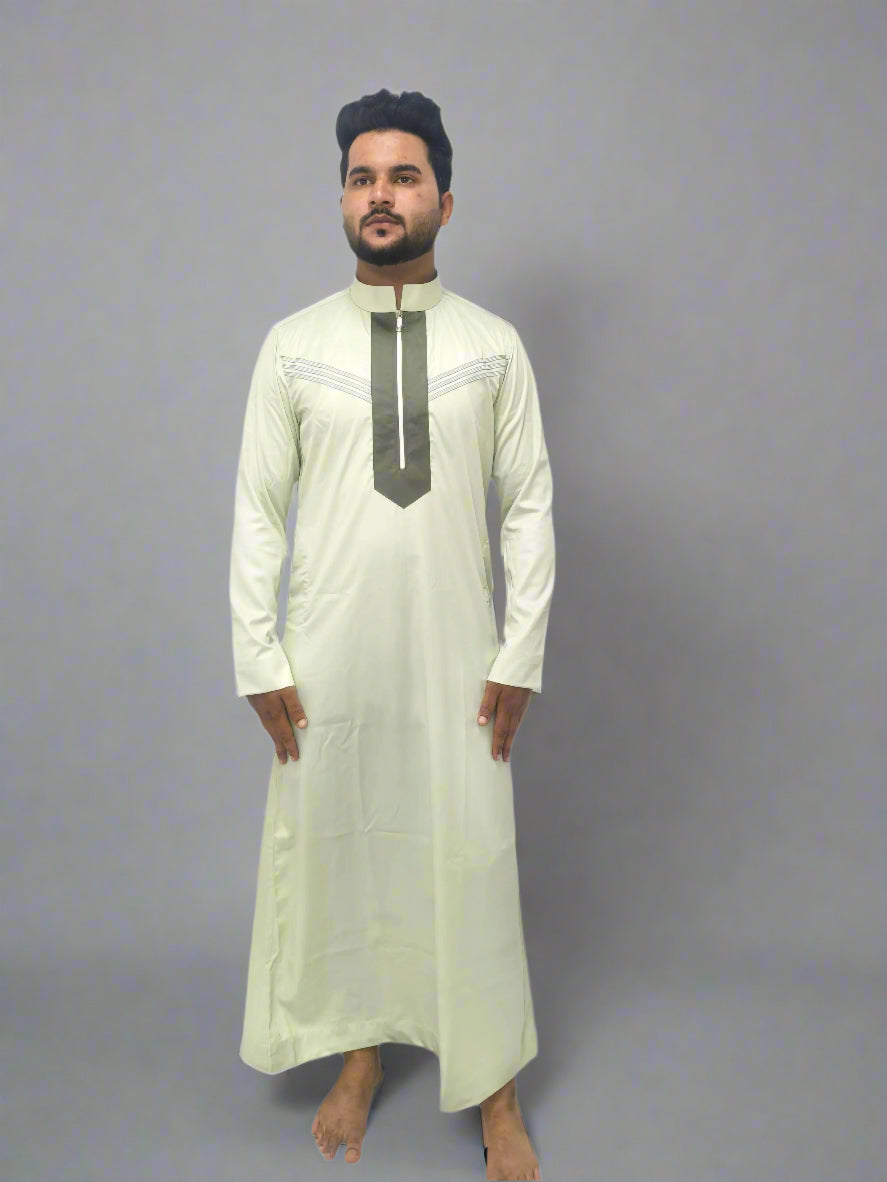 Man wearing a light-colored traditional outfit with a dark collar against a white background